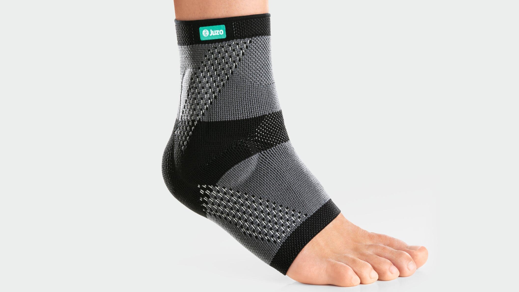Someone is running along a dirt track, wearing an ankle support Someone is running along a dirt track, wearing an ankle support